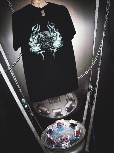 The Null Object collaboration tee, and Hot Wheels die-casts with the Daikoku mark engraved into them. Limited runs, sold at the show, funding the programming